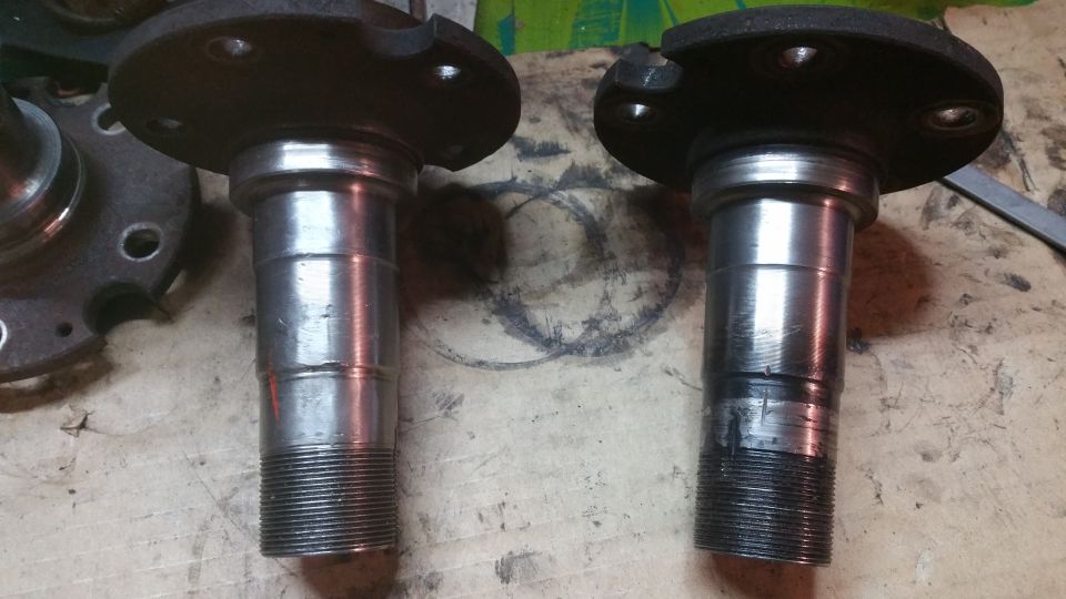 Two metal wheel hubs with threaded ends and bolt holes.