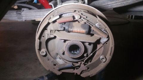 1996 Ford Bronco - The image shows the internal components of a drum brake assembly, likely from a 1996 Ford Bronco. Visible parts include brake shoes, spring…