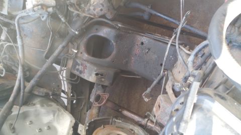1996 Ford Bronco - This is a close-up, high-angle view of the engine bay of a 1996 Ford Bronco. The image shows various engine components, hoses, and wiring h…