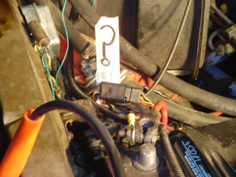 1978 Ford Bronco - A close-up view of a vehicle's engine bay, various wires and a prominent question mark tag.