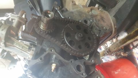 1996 Ford Bronco - A close-up view of the timing chain and gears on a disassembled engine block. The engine appears to be from a Ford Bronco.