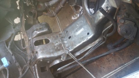 1996 Ford Bronco - This image shows the engine bay of a vehicle, focusing on the frame and some engine components. The frame appears to have been recently cle…