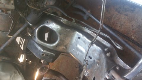 1996 Ford Bronco - The underside of a vehicle frame, likely from a 1996 Ford Bronco, is shown after being cleaned and prepped for painting. Various metal comp…