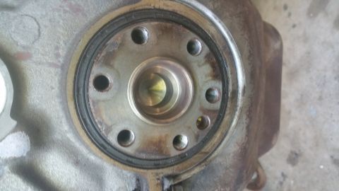 1996 Ford Bronco - A close-up view of a metal component with a circular seal and several bolt holes. The part appears to be part of a vehicle's drivetrain or…