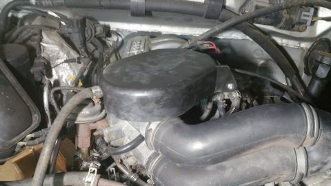 1996 Ford Bronco - The engine bay of a 1996 Ford Bronco is shown, featuring the air intake system and engine components.