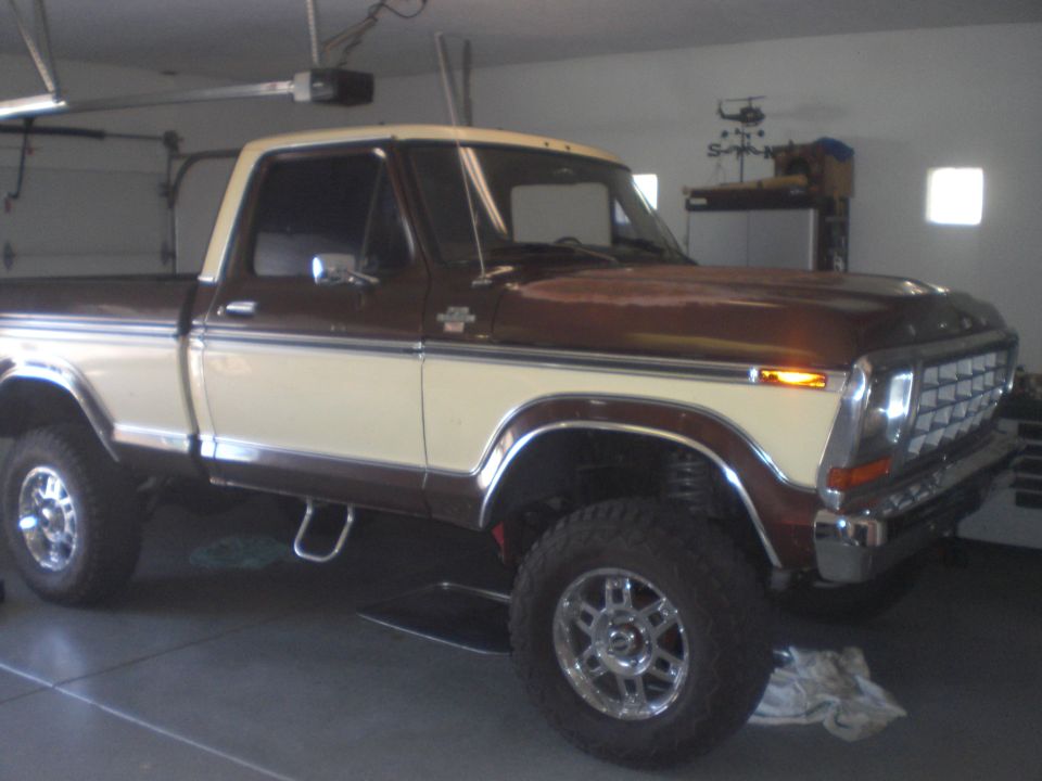 1978 Ford F-150 pickup truck, brown and cream two-tone, parked in a garage.