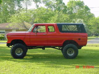 1978 Ford Bronco - This red 1978 Ford Bronco features a removable soft top and is shown in a side profile view.