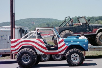 1979 Ford Bronco II - A custom-painted Ford Bronco is shown on a trailer, with another vehicle behind it.