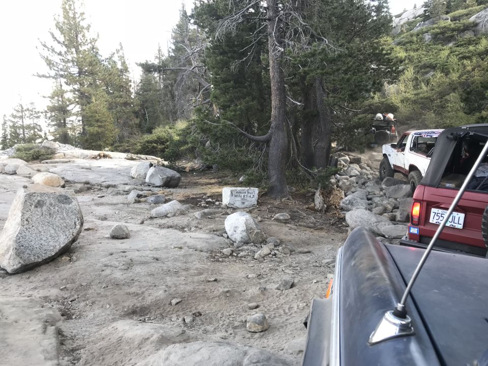 Red 1984 Ford Bronco on a rocky trail, license plate 755 JLL.