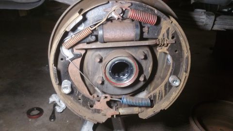 1996 Ford Bronco - This is a close-up view of the internal components of a drum brake assembly, showing the brake shoes, springs, wheel cylinder, and hub.