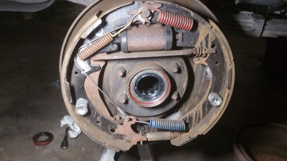 Close-up of drum brake assembly with hub, shoes, springs, and wheel cylinder.