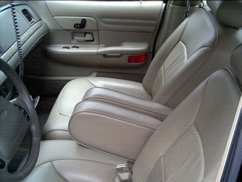 1999 Ford Crown Victoria - Interior view of a 1998 Ford Crown Victoria, highlighting the tan leather seats and dashboard details.