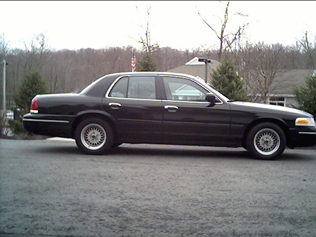Black 1998 Ford Crown Victoria sedan, side view