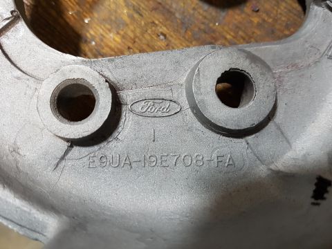 1978 Ford Bronco - A close-up shot shows a metal part with the Ford logo and part number E9UA-19E708-FA stamped into it. The part appears to be a component fr…