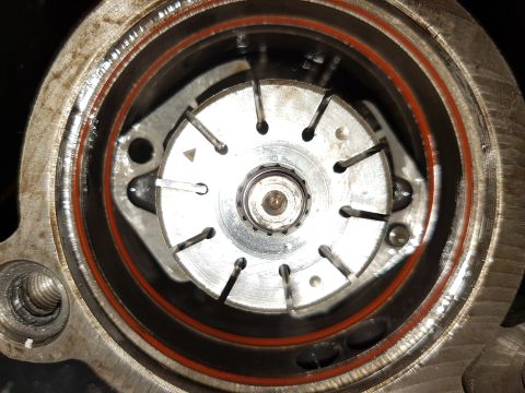 1978 Ford Bronco - A close-up, top-down view of the internal components of a mechanical device, possibly a pump or valve, with a red gasket visible around the…