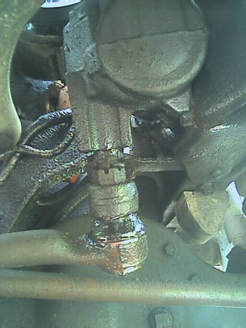 1989 Ford Bronco - A close-up of a leaking component on the underside of a vehicle, with the Supermotors.net logo in the corner.