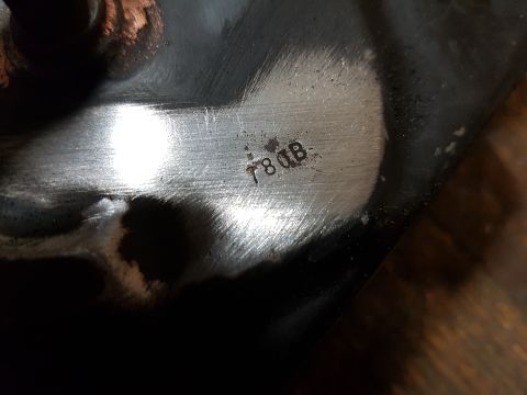 1978 Ford Bronco - A close-up shot shows stamped text on a metallic surface. The text reads "78 DB" and appears to be part of a vehicle component.