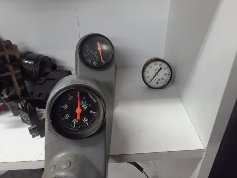 1994 Ford Bronco - A close-up shot shows two automotive gauges mounted on a gray bracket. The lower gauge reads 'VAC' and measures vacuum in inches of mercury…