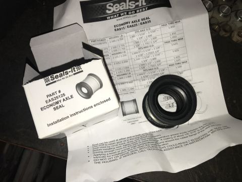 1989 Ford Bronco - Seals-It economy axle seal and its installation guide are laid out on a surface.