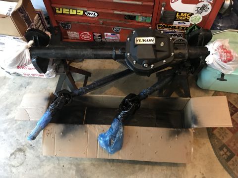 1989 Ford Bronco - A Yukon differential axle assembly is shown on jack stands, with its driveshafts covered in protective wrapping.