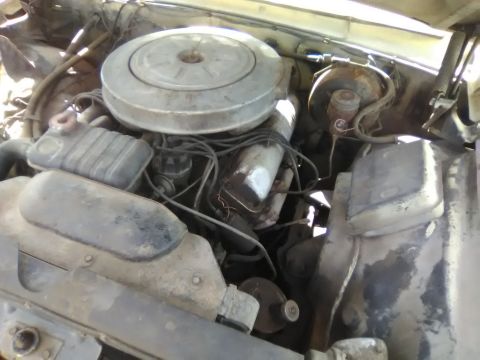 1961 Ford Starliner - Close-up view of a car's engine bay, showing various components and wiring.