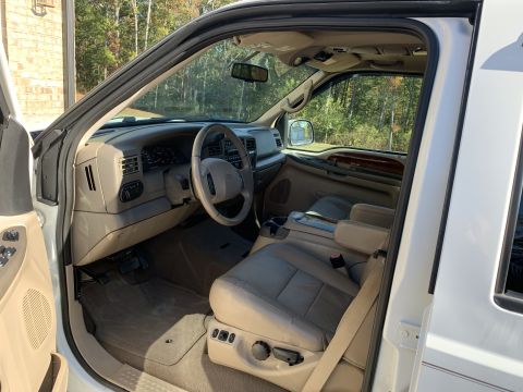 2009 Harley-Davidson FLH - Interior of a white Ford Super Duty truck, showing the driver's seat and dashboard.
