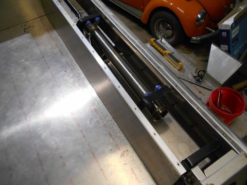 1992 Ford Bronco - An exhaust pipe assembly is shown in detail, with a vintage orange car in the background.