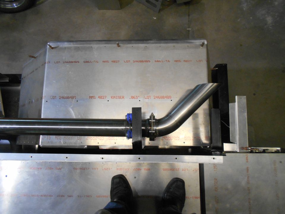 Exhaust pipe attached to metal sheeting with visible lot numbers and text