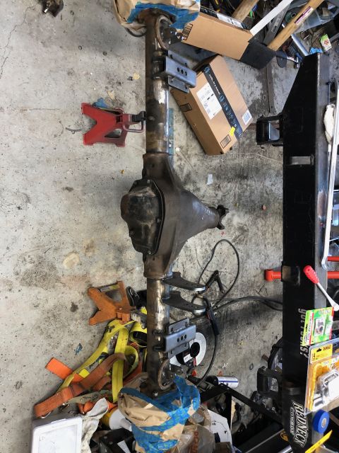 1992 Jeep Wrangler - A rear axle assembly is shown, likely for a Jeep Wrangler, with its differential housing and various mounting components.