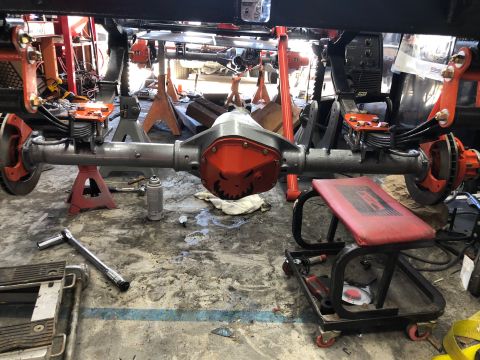 1992 Jeep Wrangler - A rear axle assembly is shown in a garage, undergoing maintenance or repair.