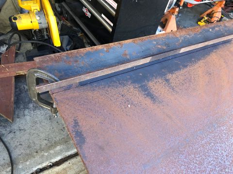 1992 Jeep Wrangler - Metal sheet being worked on, with tools and a toolbox visible in the garage setting.