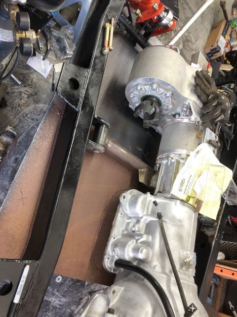 1992 Jeep Wrangler - The image shows a vehicle's frame with transmission and transfer case components being worked on.