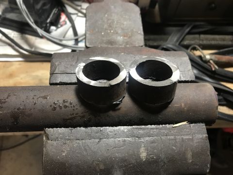 1989 Ford Bronco - Two metal pipe sections are clamped in a vise, ready for further work.