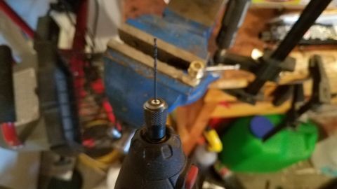 1985 Ford Bronco - A drill bit is secured in the chuck of a rotary tool, ready for use with a vise in the background.