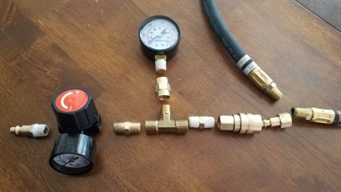1985 Ford Bronco - Air pressure gauge and fittings assembled for a leakdown tester.