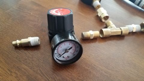 1985 Ford Bronco - This is a close-up of an air pressure regulator and various brass fittings, likely for a homemade tool.