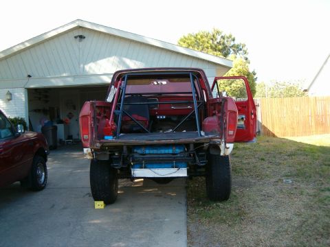 1979 Ford Bronco - This 1979 Ford Bronco is viewed from the rear, showing its custom roll cage and open doors.