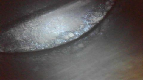 1985 Ford Bronco - The image shows a close-up of an engine cylinder wall, revealing significant wear and debris.
