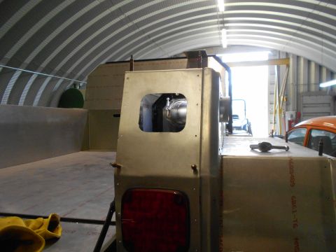 1992 Ford Bronco - Workshop scene with a custom truck bed build in progress; an orange car is visible in the background.