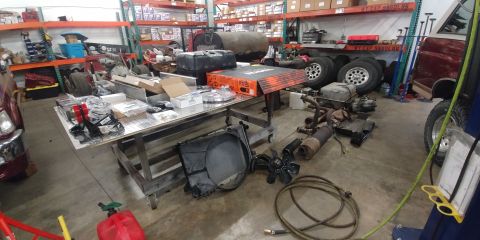 1996 Ford Bronco - 20191021 - Most of the new parts are on the table, all the old stuff pulled out is on the ground in front of and to the right of the table.…