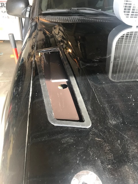 2000 Ford Explorer - Detail of a car hood vent, with a fan visible to the right.