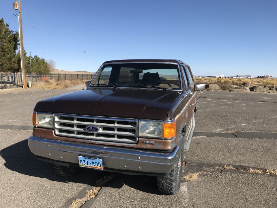 Brown 1987 Ford Bronco parked on asphalt, Nevada license plate 837-K80 visible