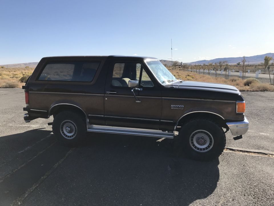 Side view of a 1988 Ford Bronco with wood paneling