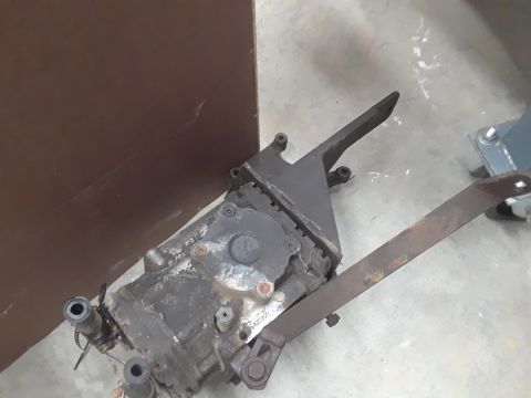 1994 Ford Bronco - A transfer case with its associated shifter linkage is shown, likely a component from a vehicle.