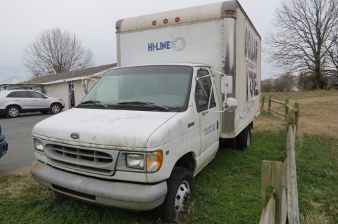 1998 Ford E350 - This 1998 Ford E350 box truck is parked on a grassy lot next to a silver SUV.