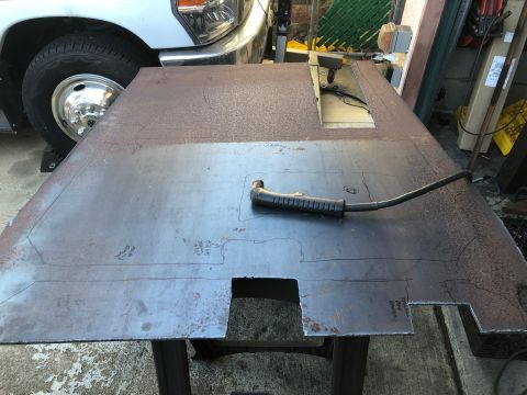 1992 Jeep Wrangler - A metal sheet is prepared for cutting with a plasma cutter, with a truck visible in the background.