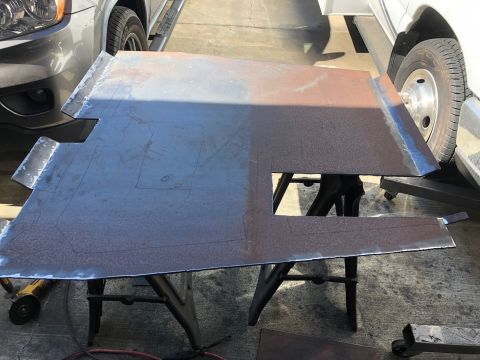 1992 Jeep Wrangler - A custom metal part is prepared for installation, with other vehicles visible in the background.