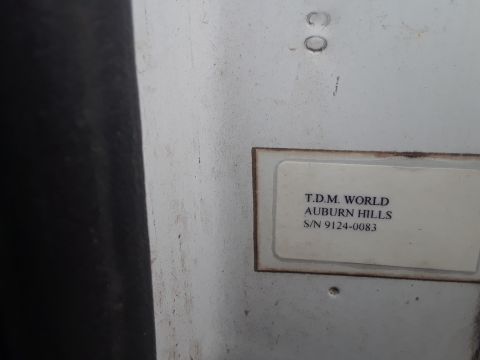 1994 Ford Bronco - A label with T.D.M. WORLD AUBURN HILLS and S/N 9124-0083 is visible on a white surface.