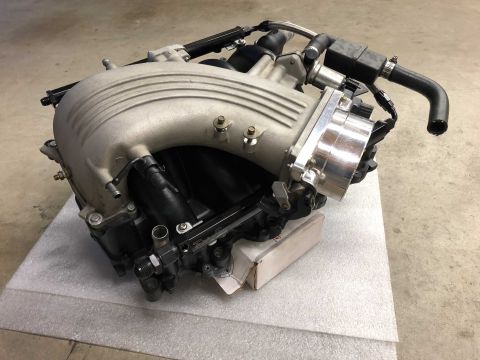 1998 Ford Crown Victoria - Engine intake manifold assembly, likely for a V8 engine, shown on a white surface.