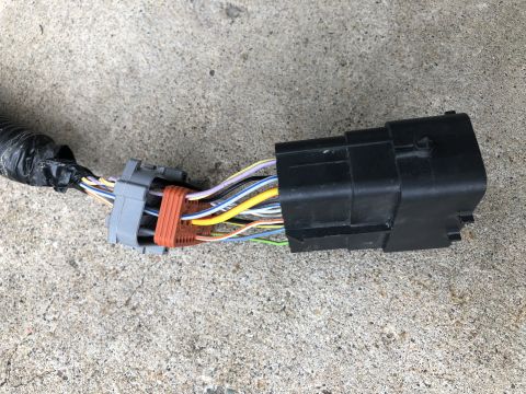 2015 Ford Explorer - A close-up view of a vehicle's wiring harness connector with various colored wires.